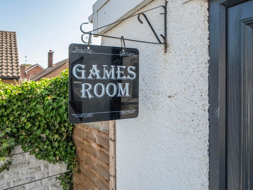 A sign indicating a games room at 58 Clifton Rise Abergele
