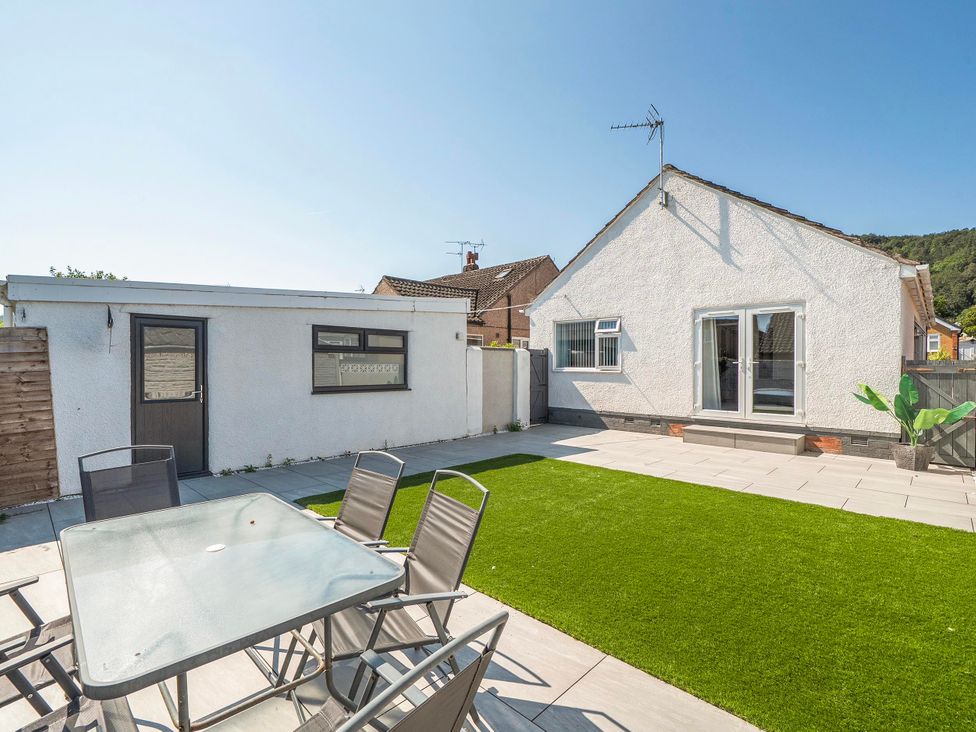 A garden with outdoor furniture and lawn at 58 Clifton Rise in Abergele