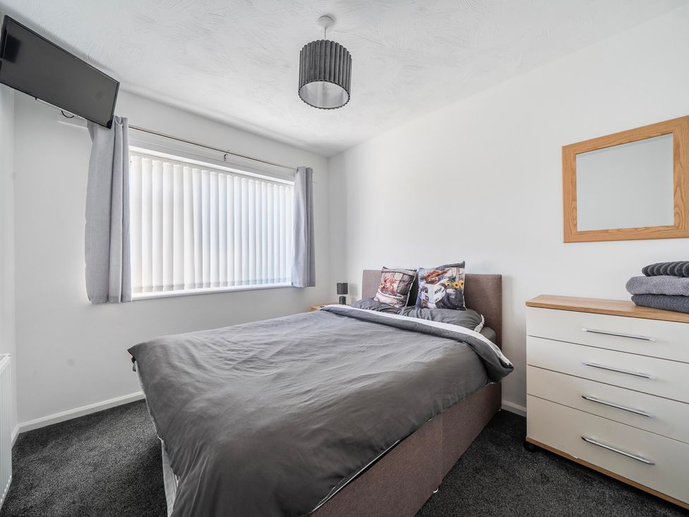 A bedroom with a bed and dresser at 58 Clifton Rise Abergele