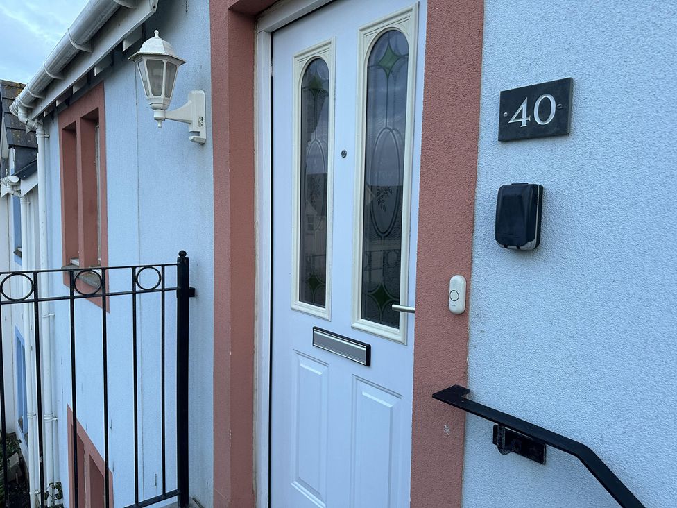 A door with a light fixture and house number at Acorn Court, 