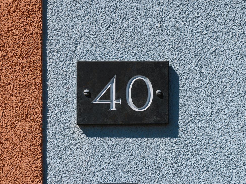 A number 40 plaque on a wall at Acorn Court