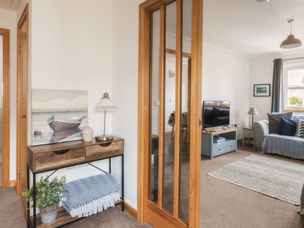 A living room with a couch and television at Acorn Court