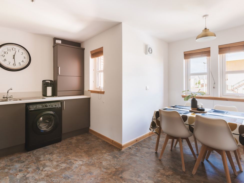 A kitchen with a sink and washing machine at Acorn Court