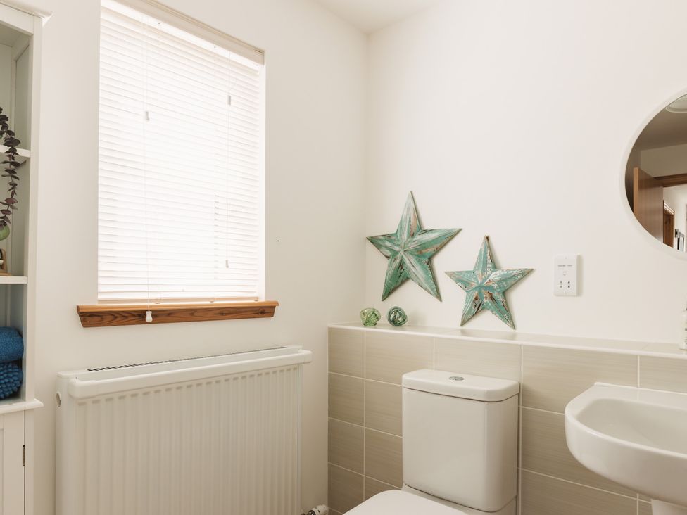 A bathroom with a toilet and sink at Acorn Court