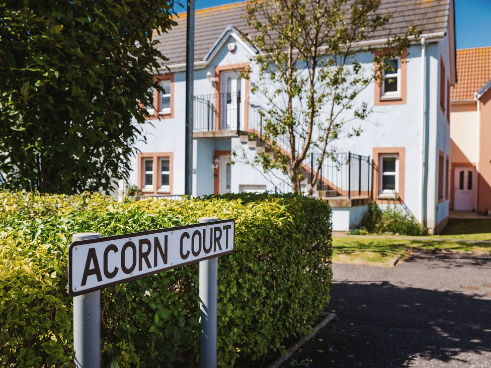 A view of Acorn Court with a sign in front of the building