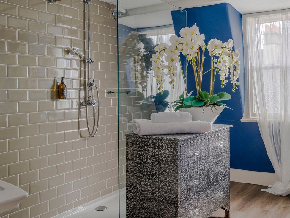 A bathroom with a shower and towels on a cabinet at Stay Robun