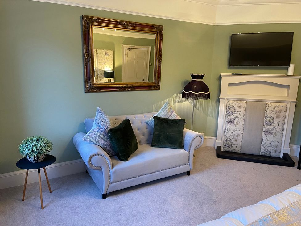 A living room with a sofa and coffee table at Stay Robun