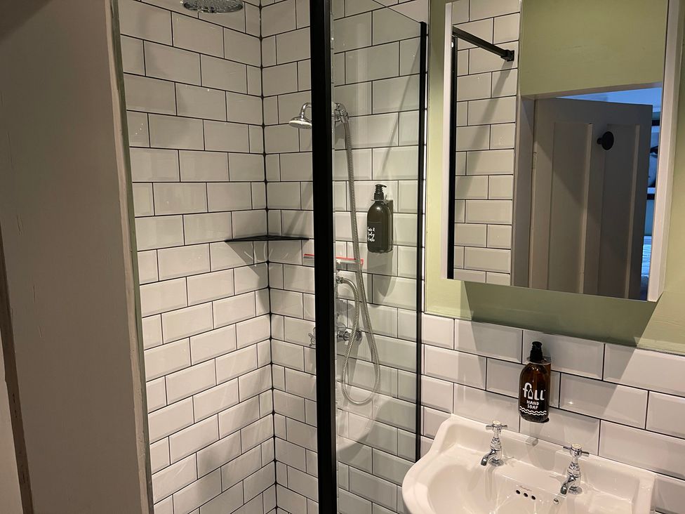 A bathroom with a shower and sink at Stay Robun in 