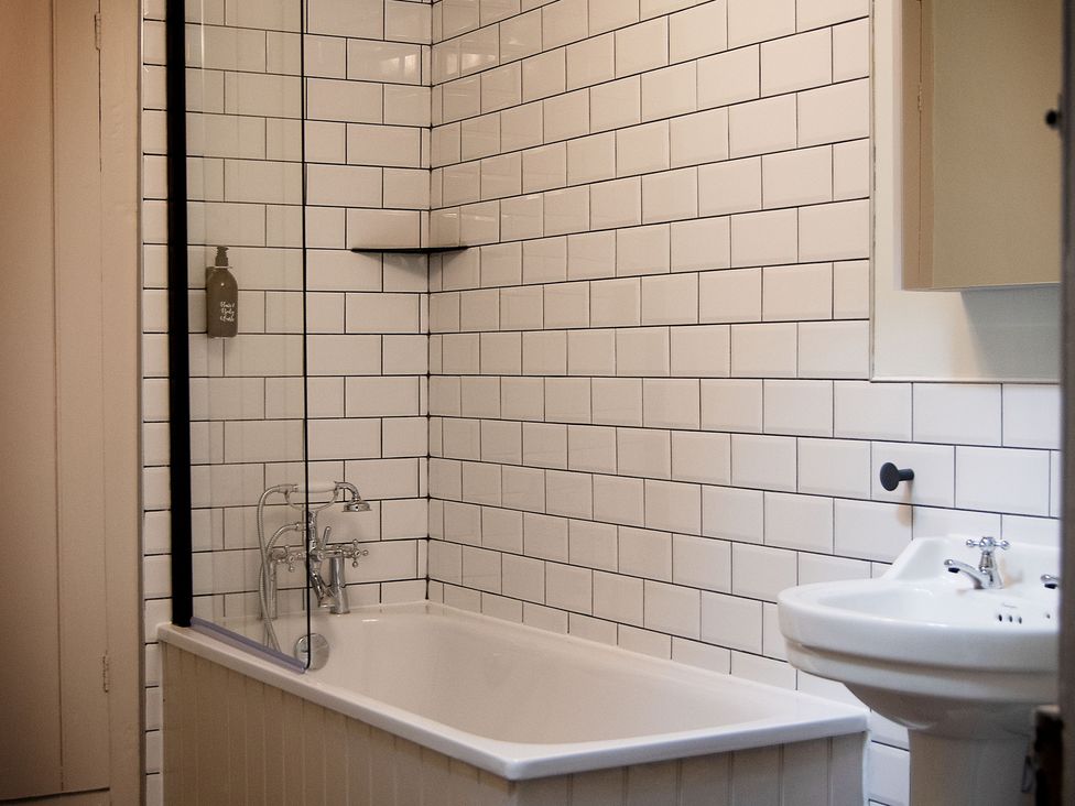A bathroom with a bathtub and sink at Stay Robun