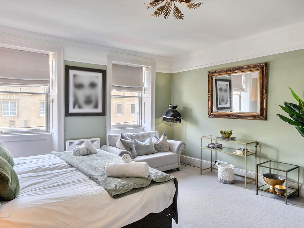 A bedroom with a bed and sofa at Stay Robun in Bath