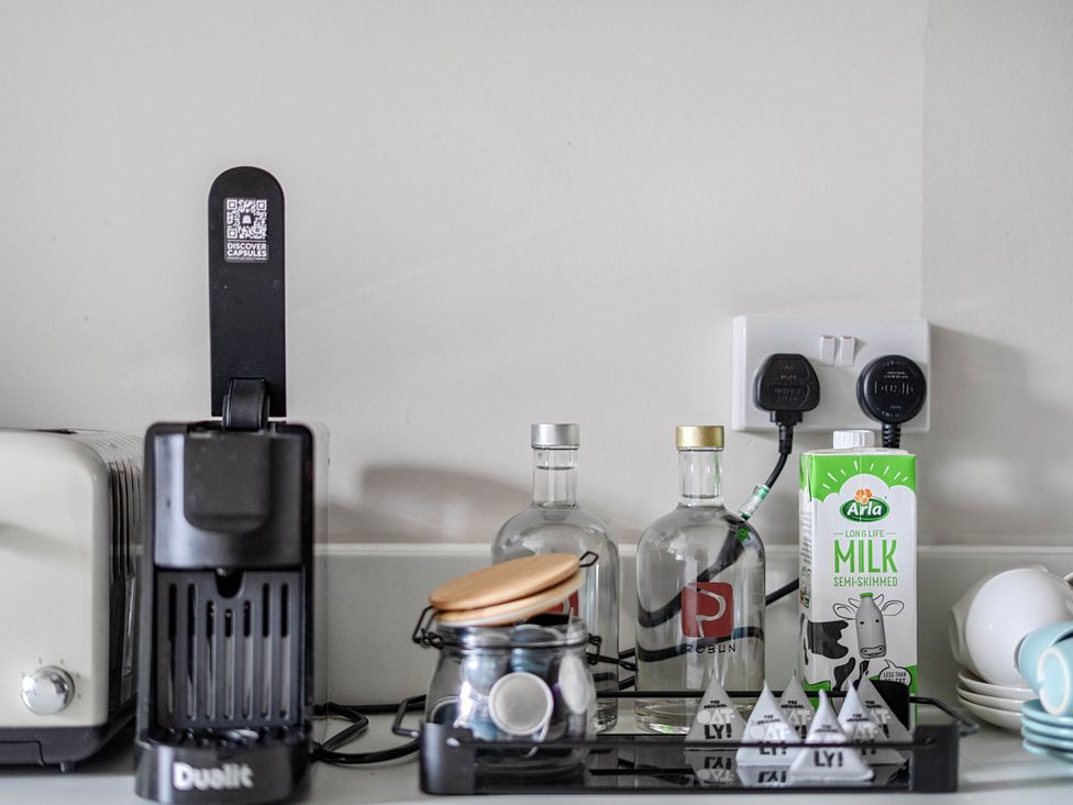 A kitchen counter with a toaster and coffee machine at Stay Robun in Bath