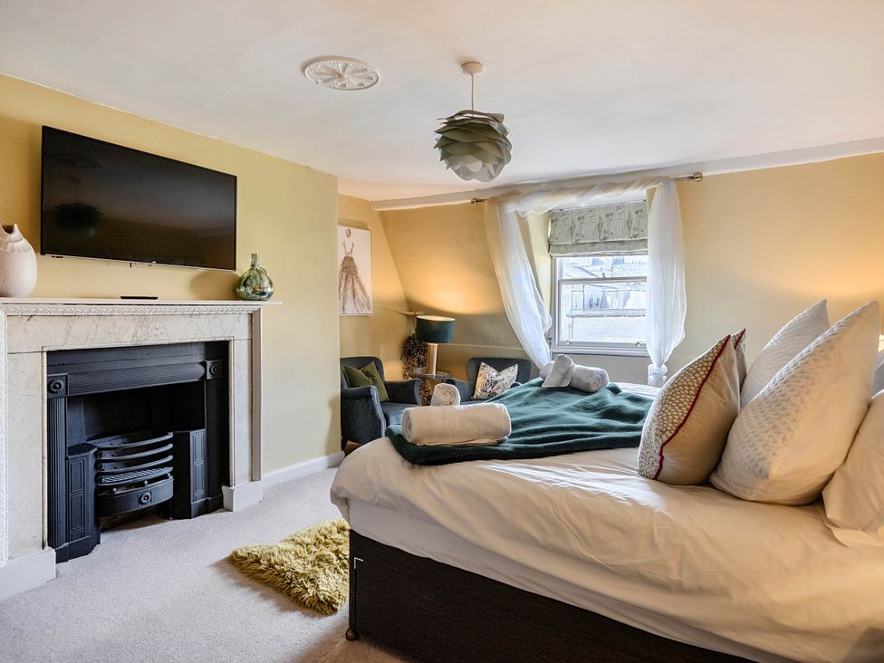A bedroom with a bed and television at Stay Robun Bath