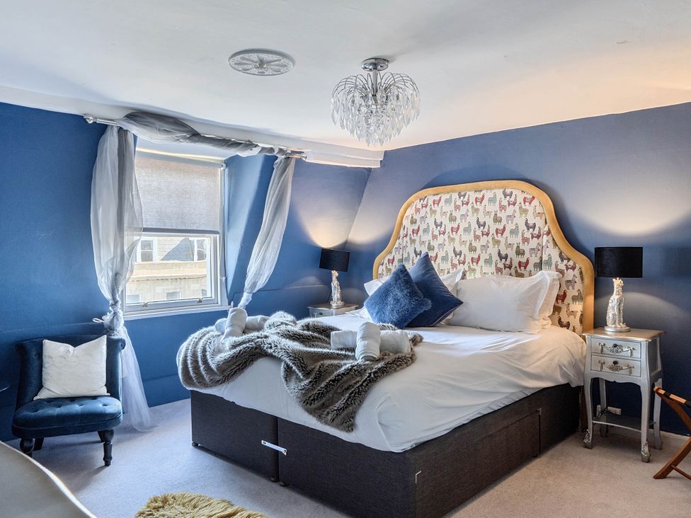 A bedroom with a bed and nightstands at Stay Robun in Bath
