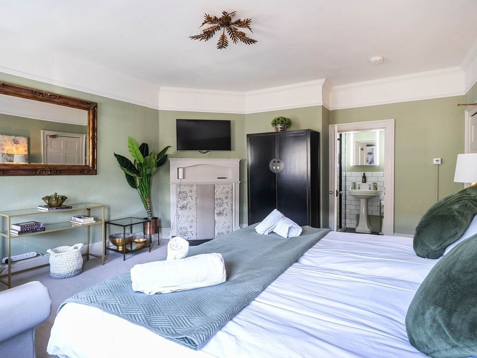 A bedroom with a bed and television at Stay Robun in Bath