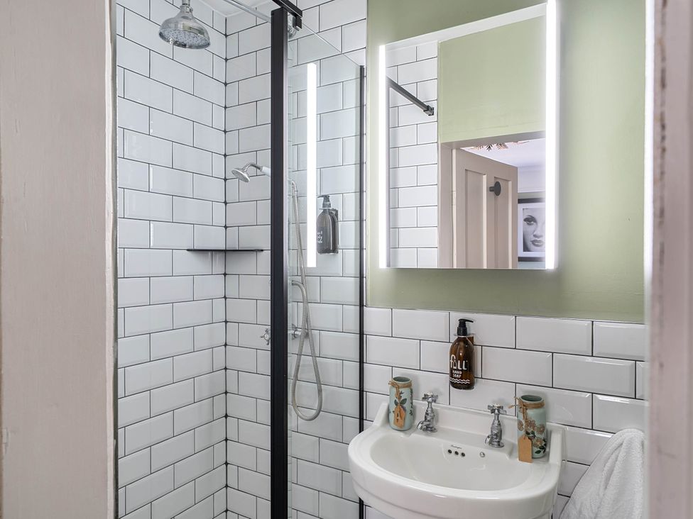 A bathroom with a shower and sink at Stay Robun in Bath