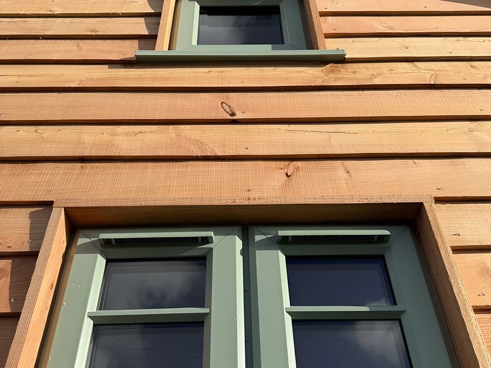Windows with wooden wall at Y Nyth in 