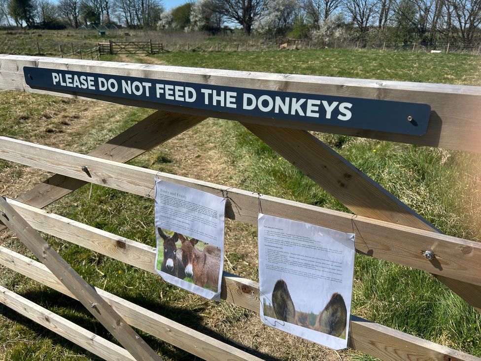A sign on a gate in a field at Y Nyth