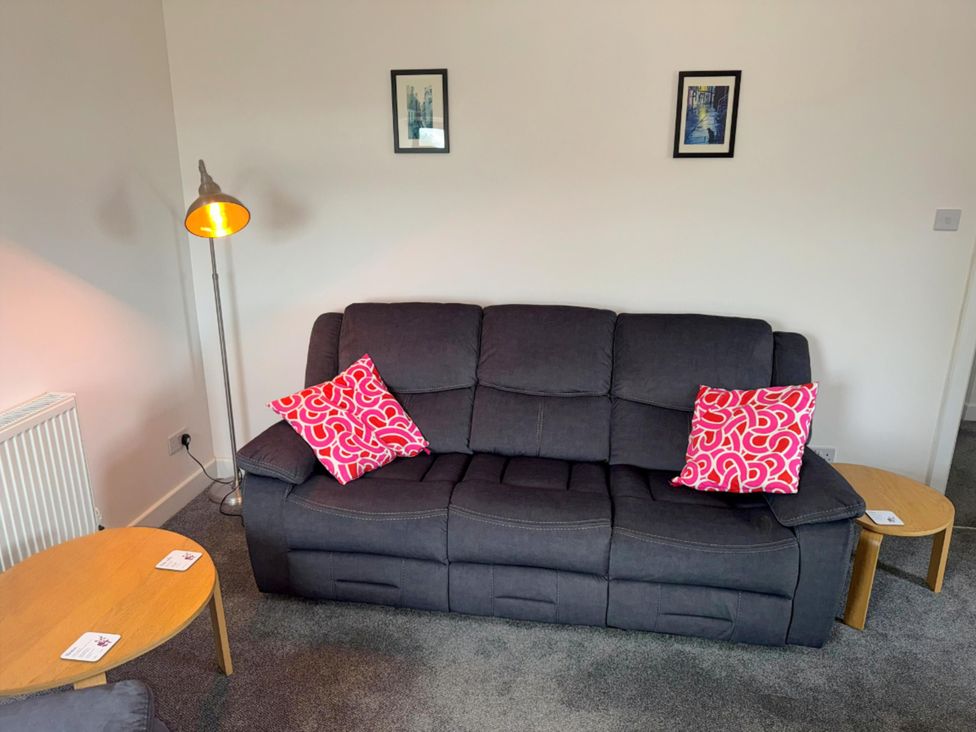 A living room with a sofa and a lamp at Withi-Gill