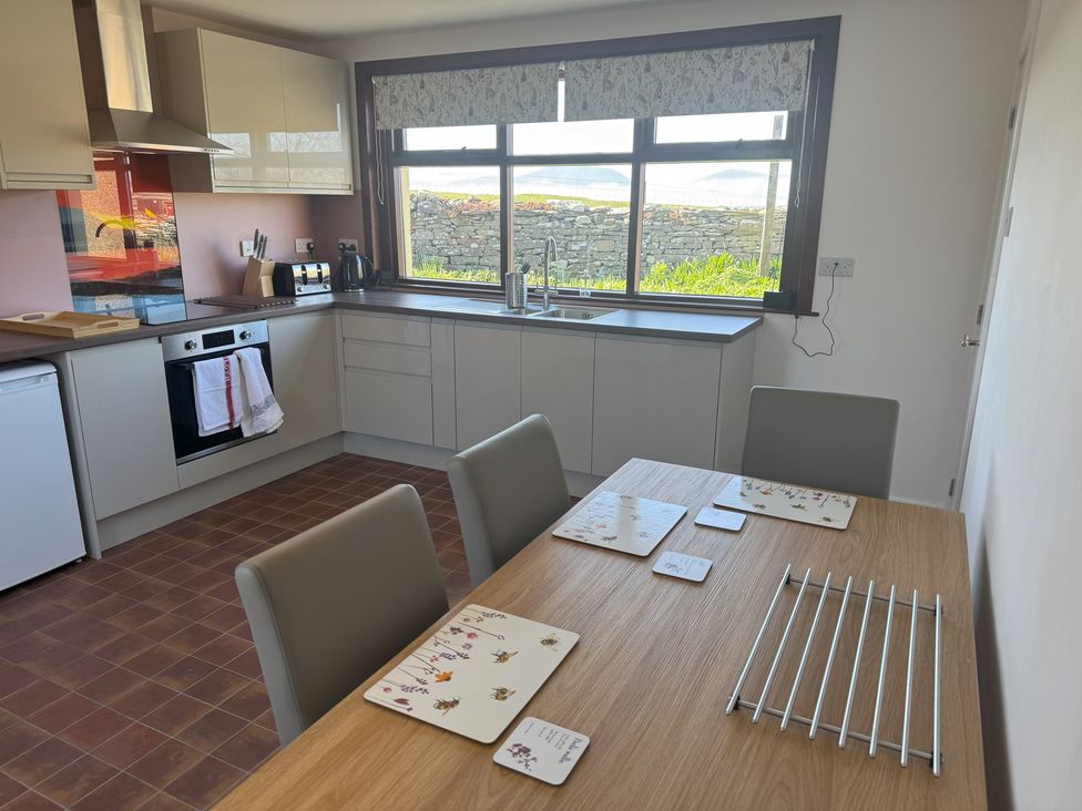A kitchen with a table and chairs at Withi-Gill