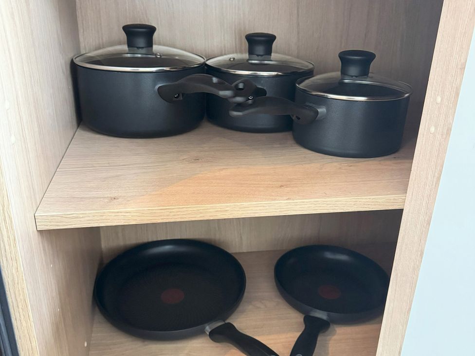 A kitchen cabinet with pots and pans at Withi-Gill