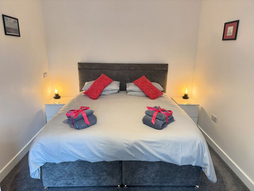 A bedroom with a bed and bedside tables at Withi-Gill