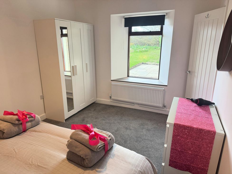 A bedroom with a bed and towels on it at Withi-Gill