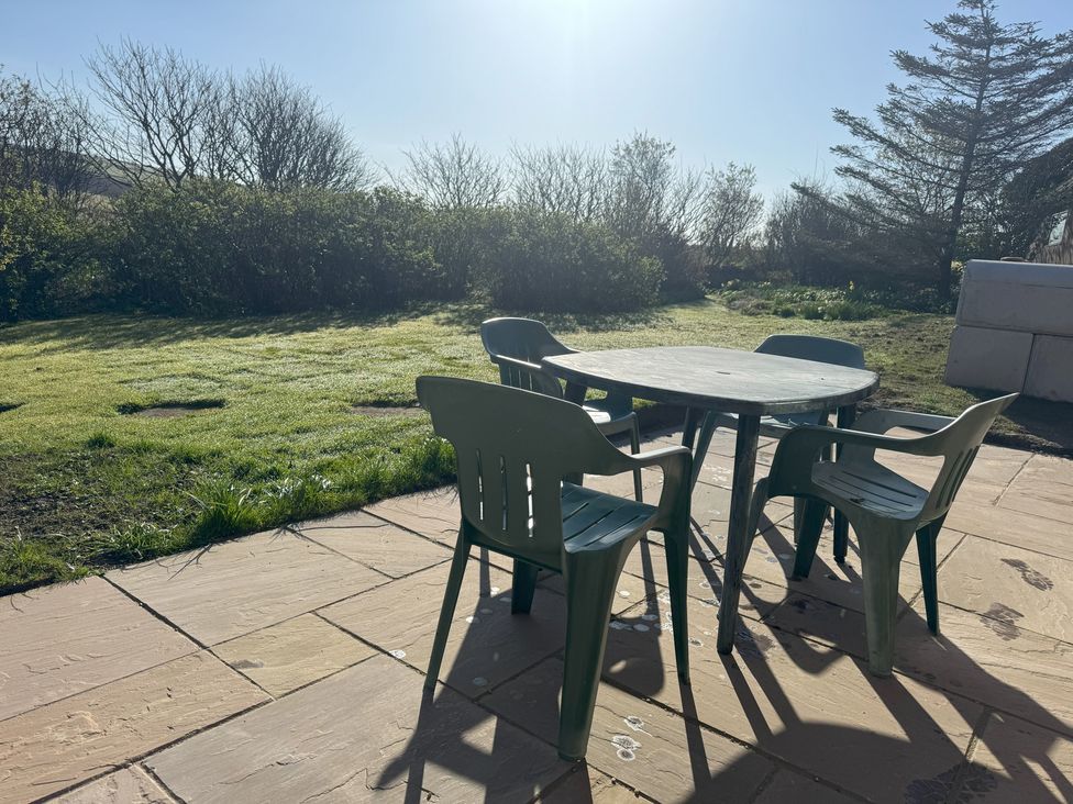 A table with chairs in a garden at Withi-Gill