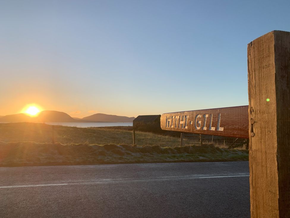 A signpost for Withi-Gill at sunrise with hills in the background