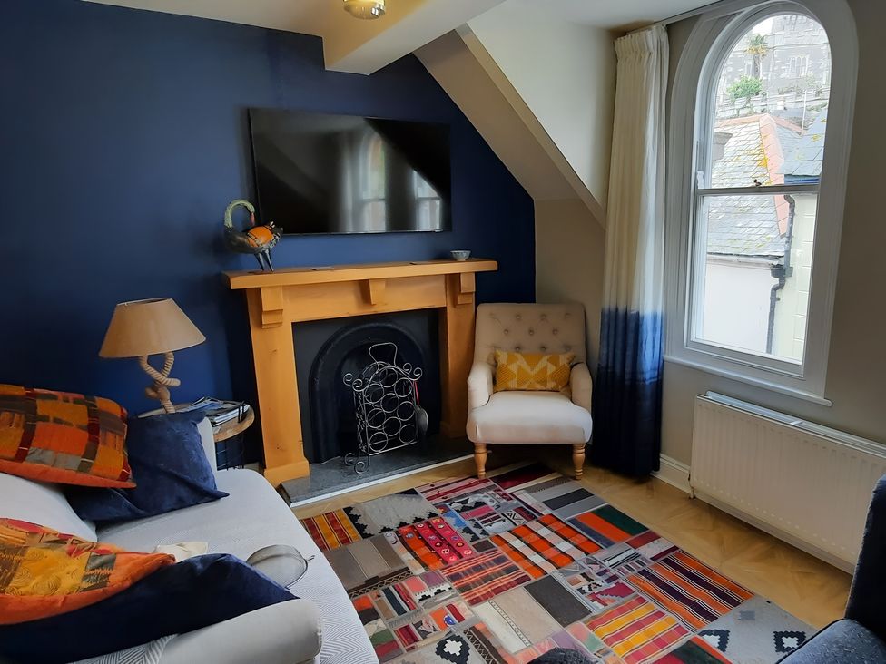 A living room with a sofa and a fireplace at Lil Nauti