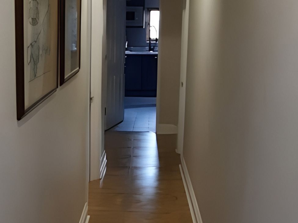 A hallway leading to a kitchen at Lil Nauti