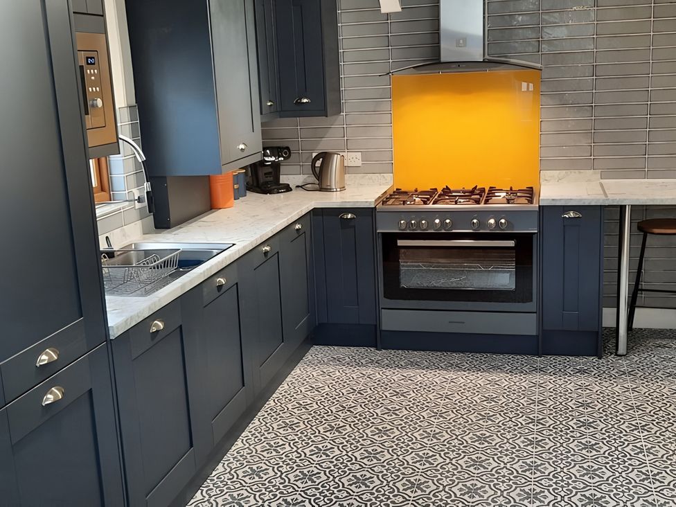 A kitchen with cabinets and appliances at Lil Nauti