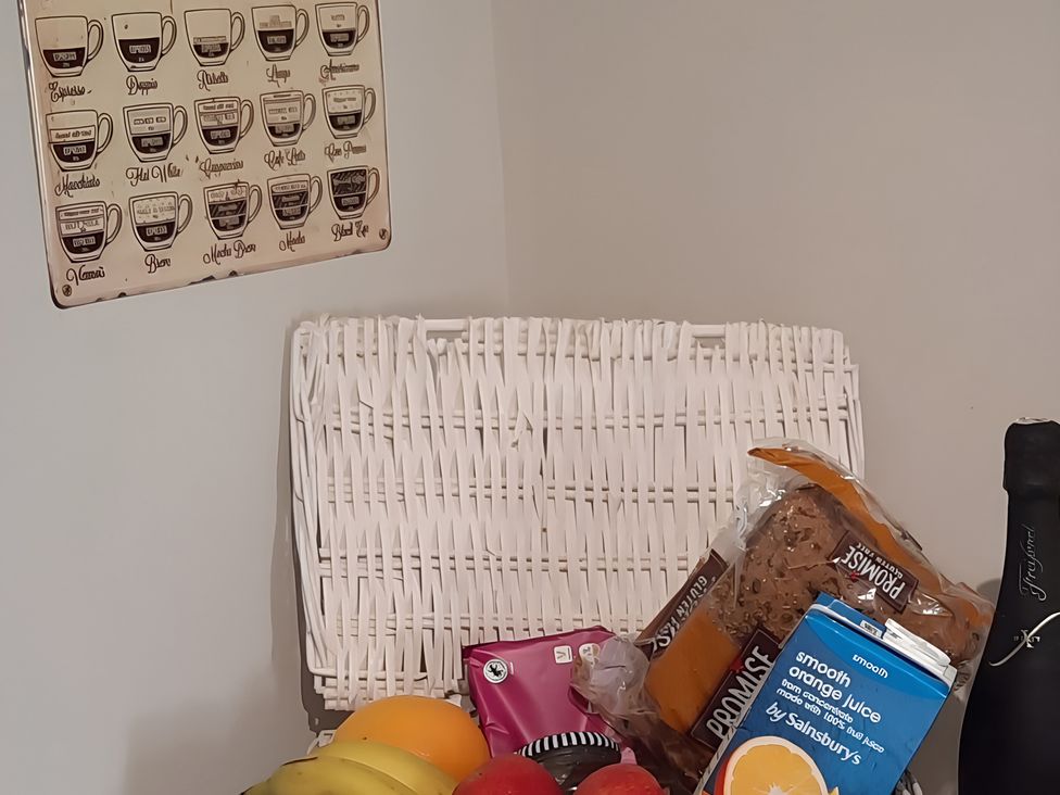 A kitchen with fruits and groceries on a table at Lil Nauti