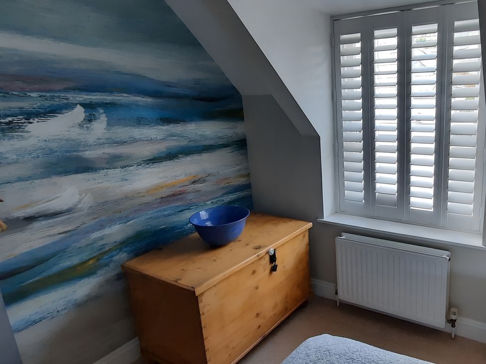 A bedroom with a wooden chest and a blue bowl at Lil Nauti