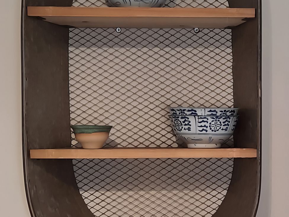 A shelf with ceramic bowls at Lil Nauti