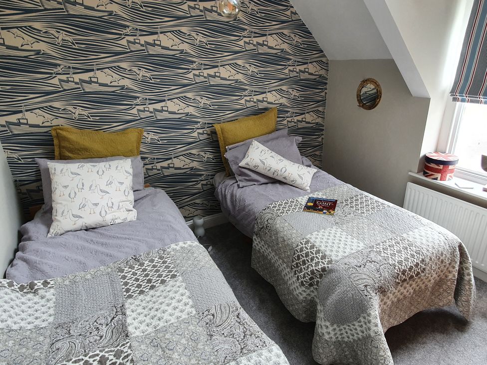 A bedroom with two beds and a window at Lil Nauti