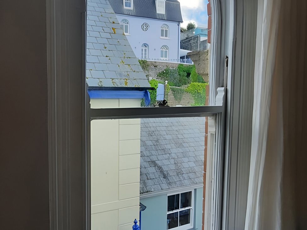 A view from a window showing rooftops and buildings at Lil Nauti