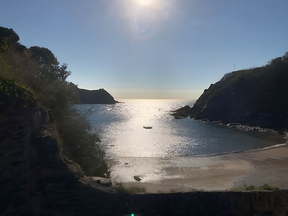 A beach with a boat in the water at Lil Nauti