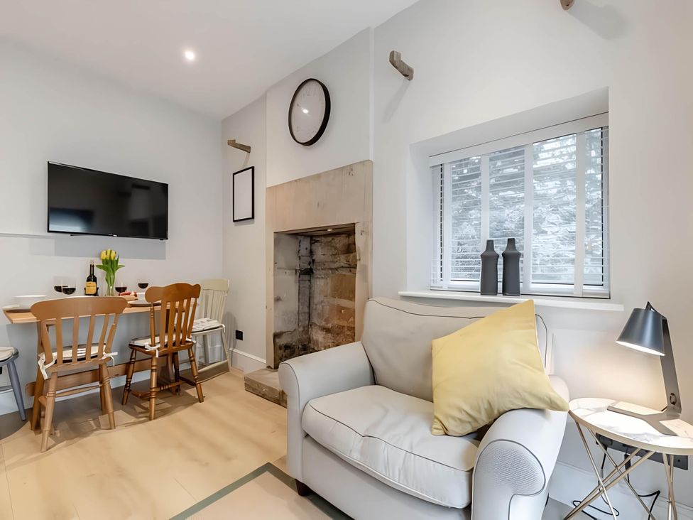 A living room with a dining table and sofa at Belmont Cottage in Matlock