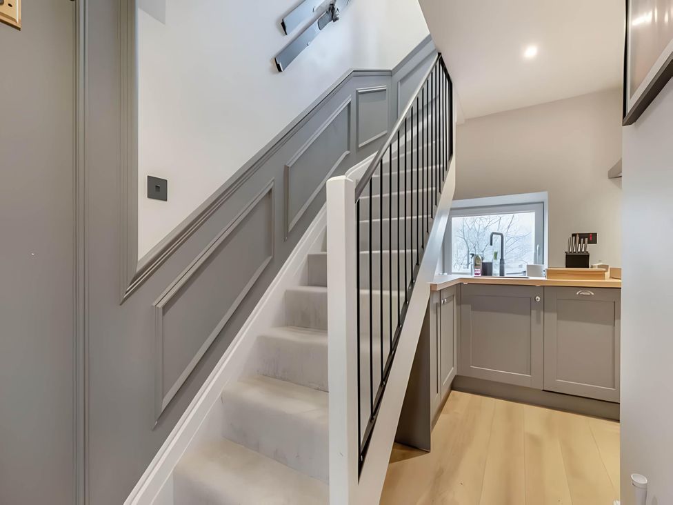 A staircase leading to a kitchen at Belmont Cottage in Matlock