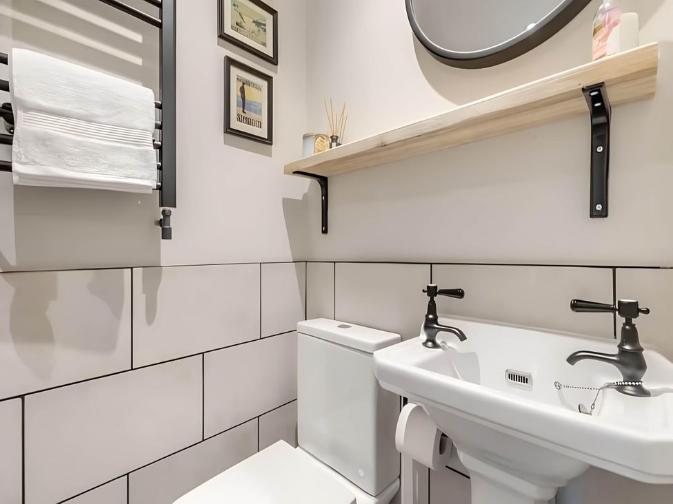 A bathroom with a sink and toilet at Belmont Cottage in Matlock