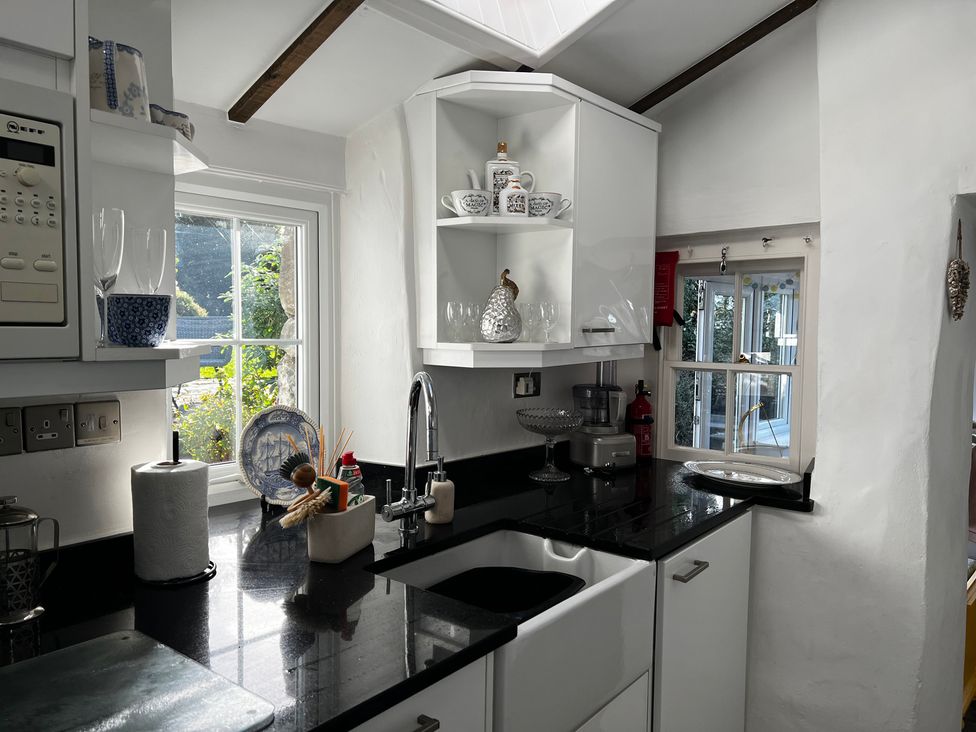 A kitchen with a sink and countertop at Bwthyn Nain
