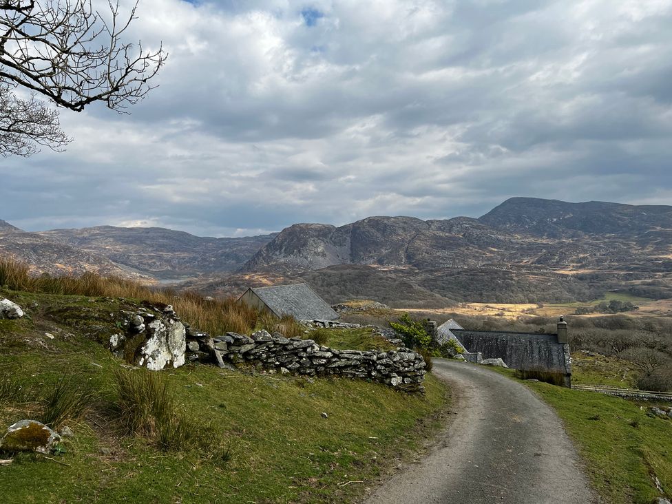 A rural landscape with mountains and a road at Bwthyn Nain 