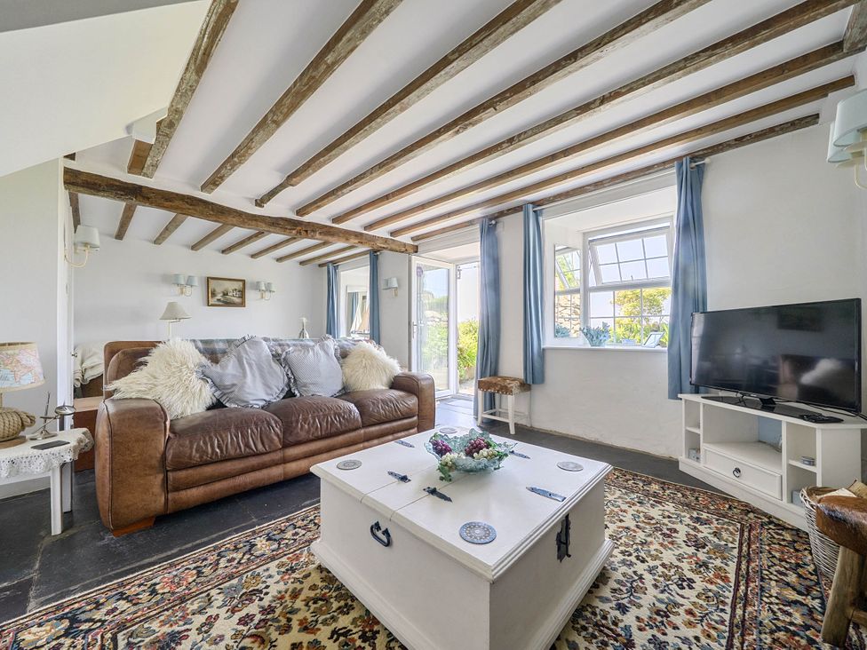 A living room with a sofa and a coffee table at Bwthyn Nain in Harlech
