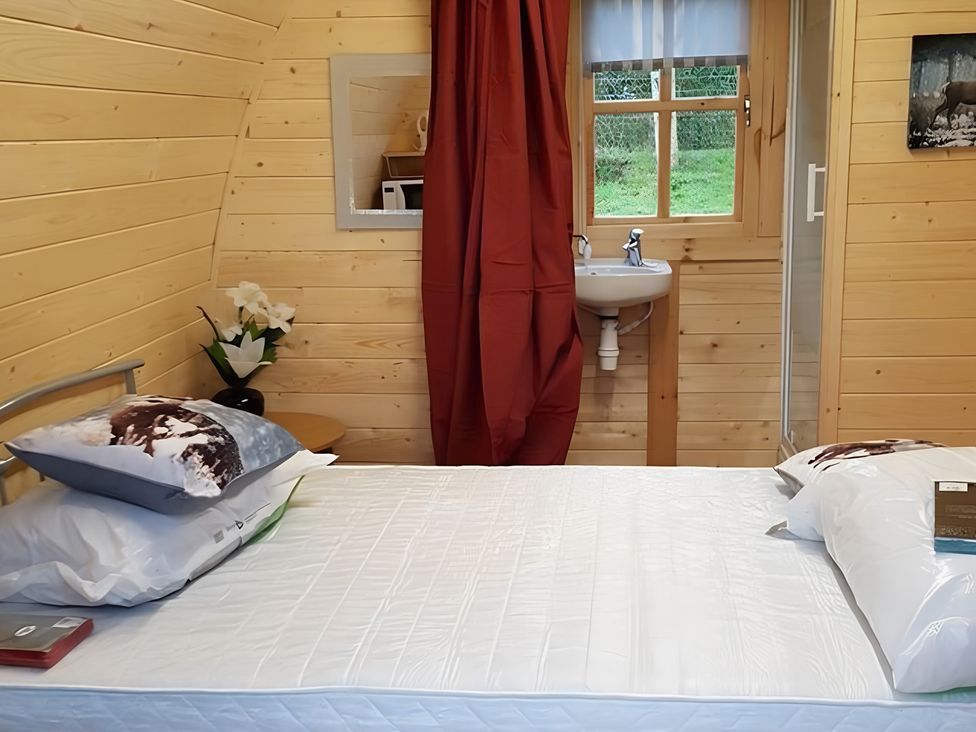 A bedroom with a bed and a sink at St Austell Glamping