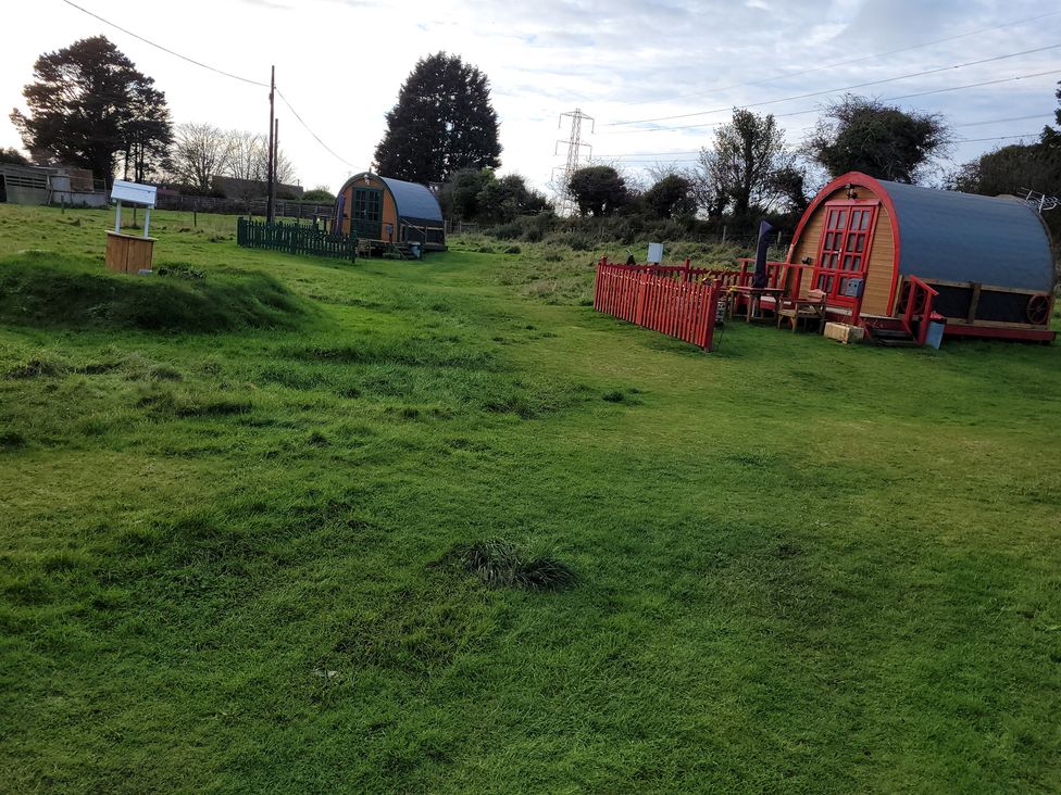 An outdoor area with unique shelters and furniture at St Austell Glamping