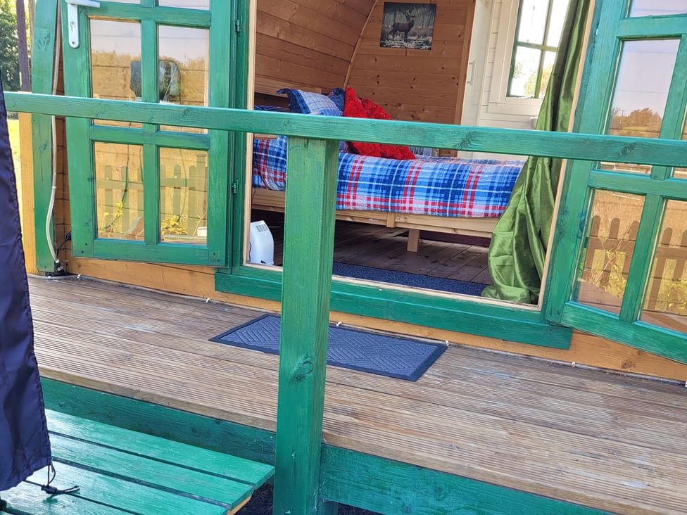 A bedroom with a bed and blanket at St Austell Glamping