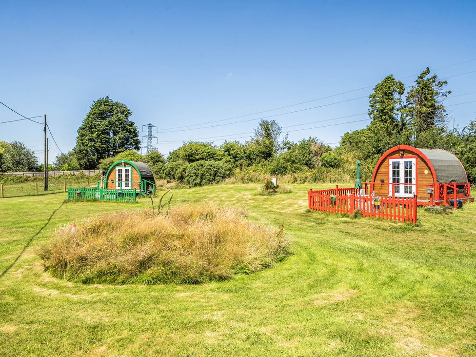 Two glamping pods in a grassy area at St Austell Glamping St Austell