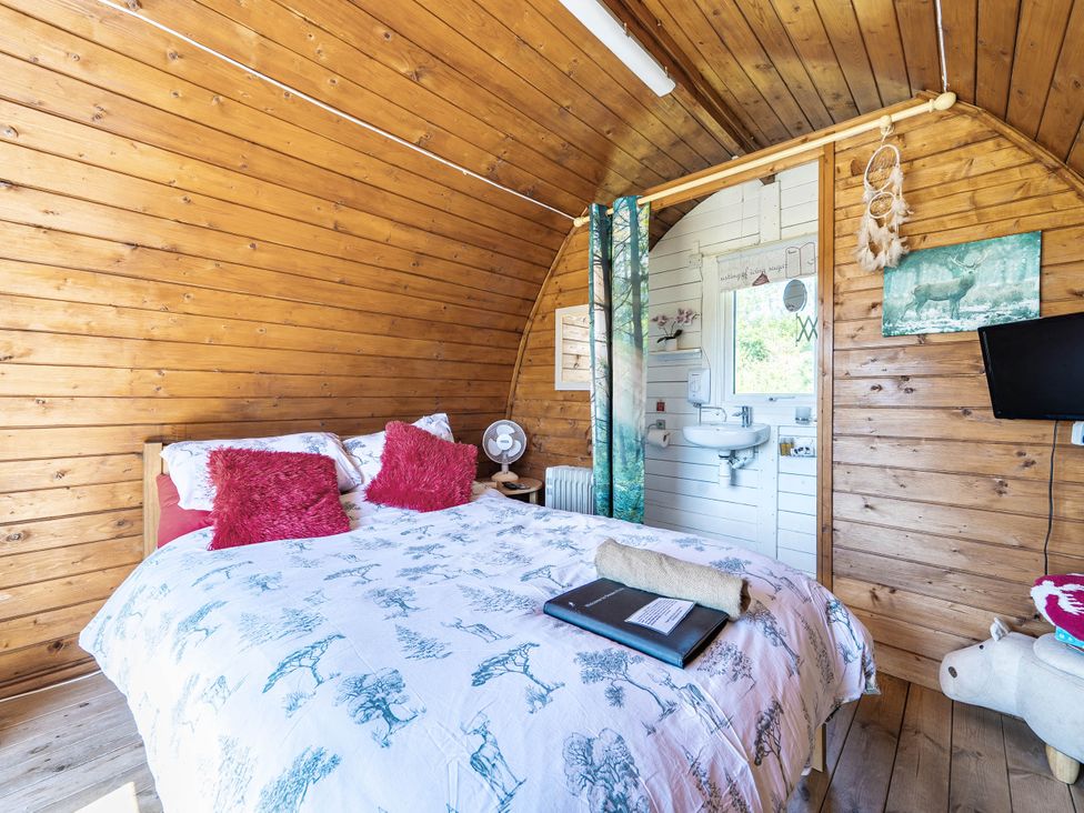 A bedroom with a bed and sink at St Austell Glamping in St Austell