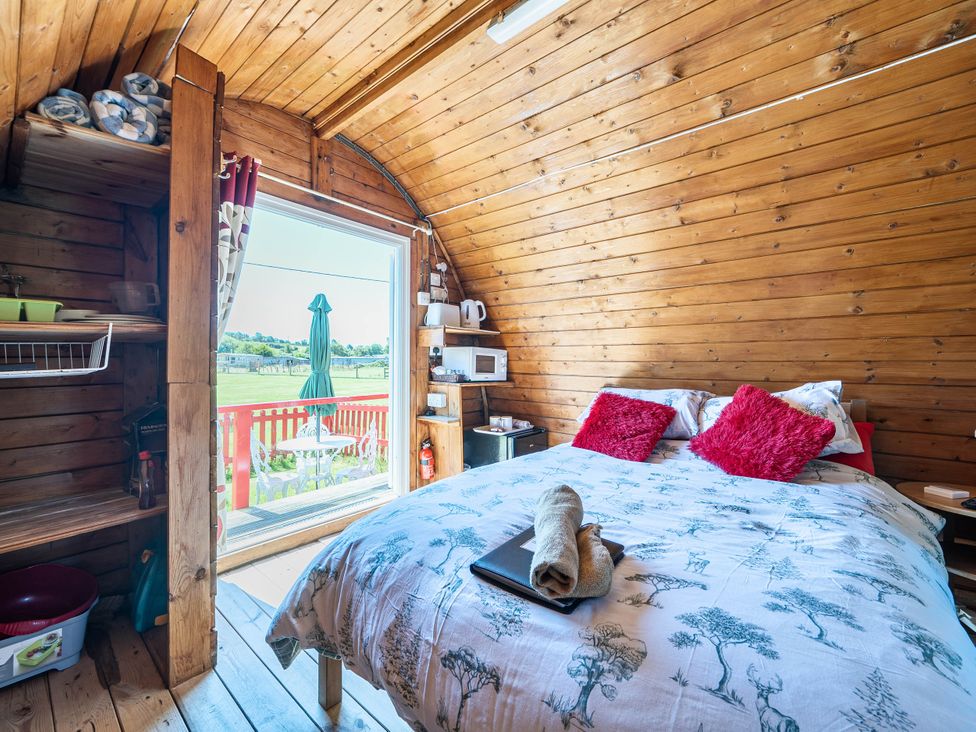 A bedroom with a bed and a window at St Austell Glamping in St Austell