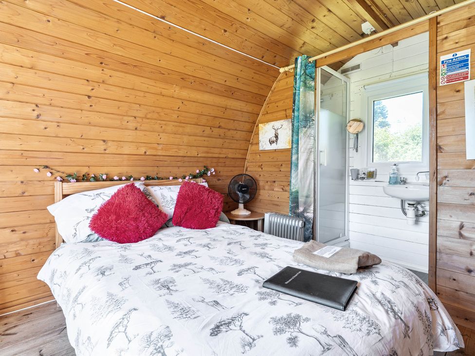 A bedroom with a bed and shower at St Austell Glamping in St Austell
